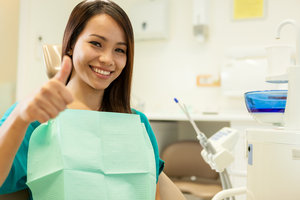 A woman enjoys smiles with dental implants. 